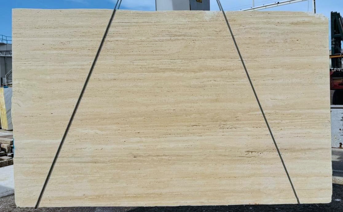 Antolini Ivory Petris travertine slab, vein cut, unfilled, in warm ivory with fine linear banding