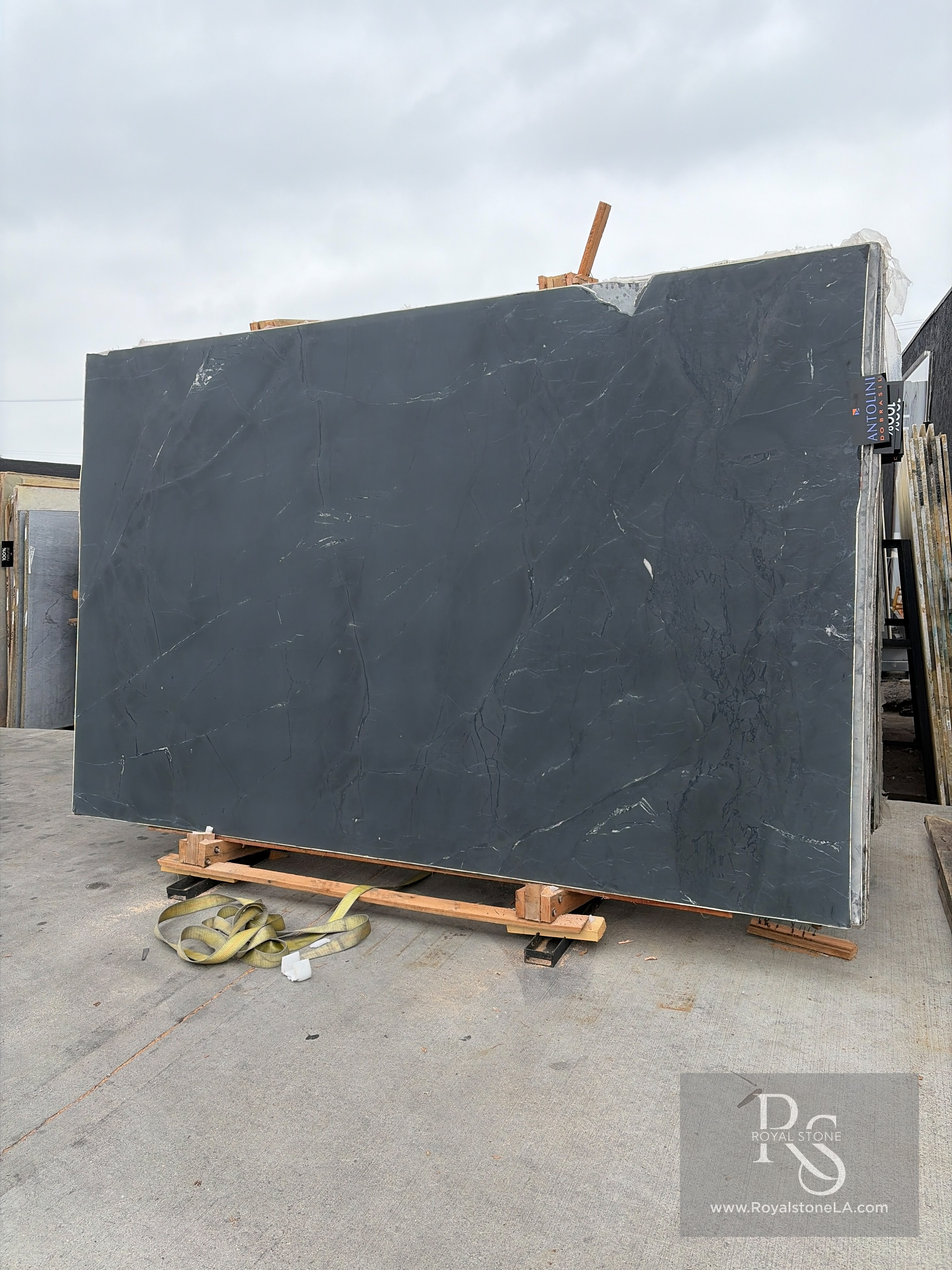 Antolini Negresco quartzite slab, 2cm honed, 78 by 124 inches, with deep charcoal-graphite field and fine white quartz veining, propped on pallets at the Royal Stone & Tile Los Angeles yard