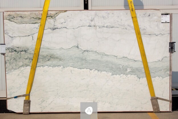 Antolini Breccia Turquoise Light marble slab with white field and a soft horizontal band of sea-green and turquoise mineralization