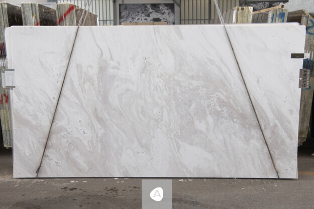 Calacatta Cremo marble slab with soft cream field and quiet taupe-grey swirl, polished