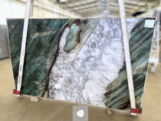 Antolini Patagonia Green quartzite slab with deep emerald-green flanks framing a translucent white-grey core, polished