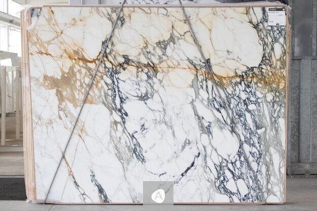 Antolini Paonazzo Antico marble slab with white field, charcoal veining, and warm gold accents