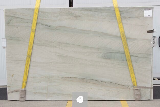 Antolini quartzite slab with soft pale green field and quiet horizontal movement