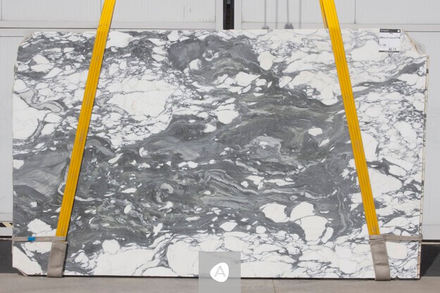 Marble slab with white ground broken by bold grey-green swirling veining