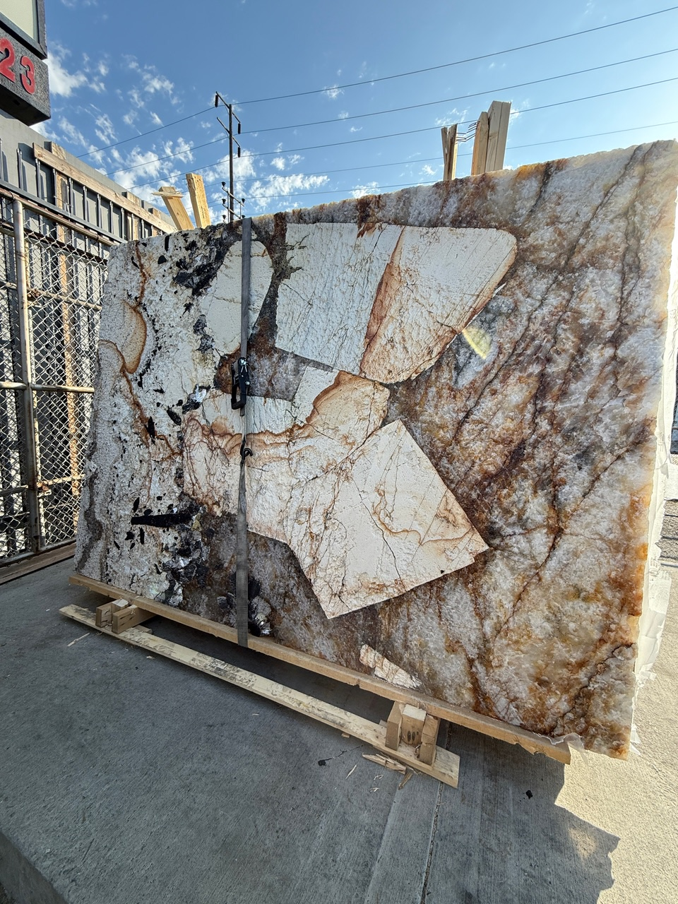 Antolini Patagonia Original quartzite slab in Hard Rock finish at Royal Stone Los Angeles, ivory and amber field with rust veining and deep sculpted surface relief