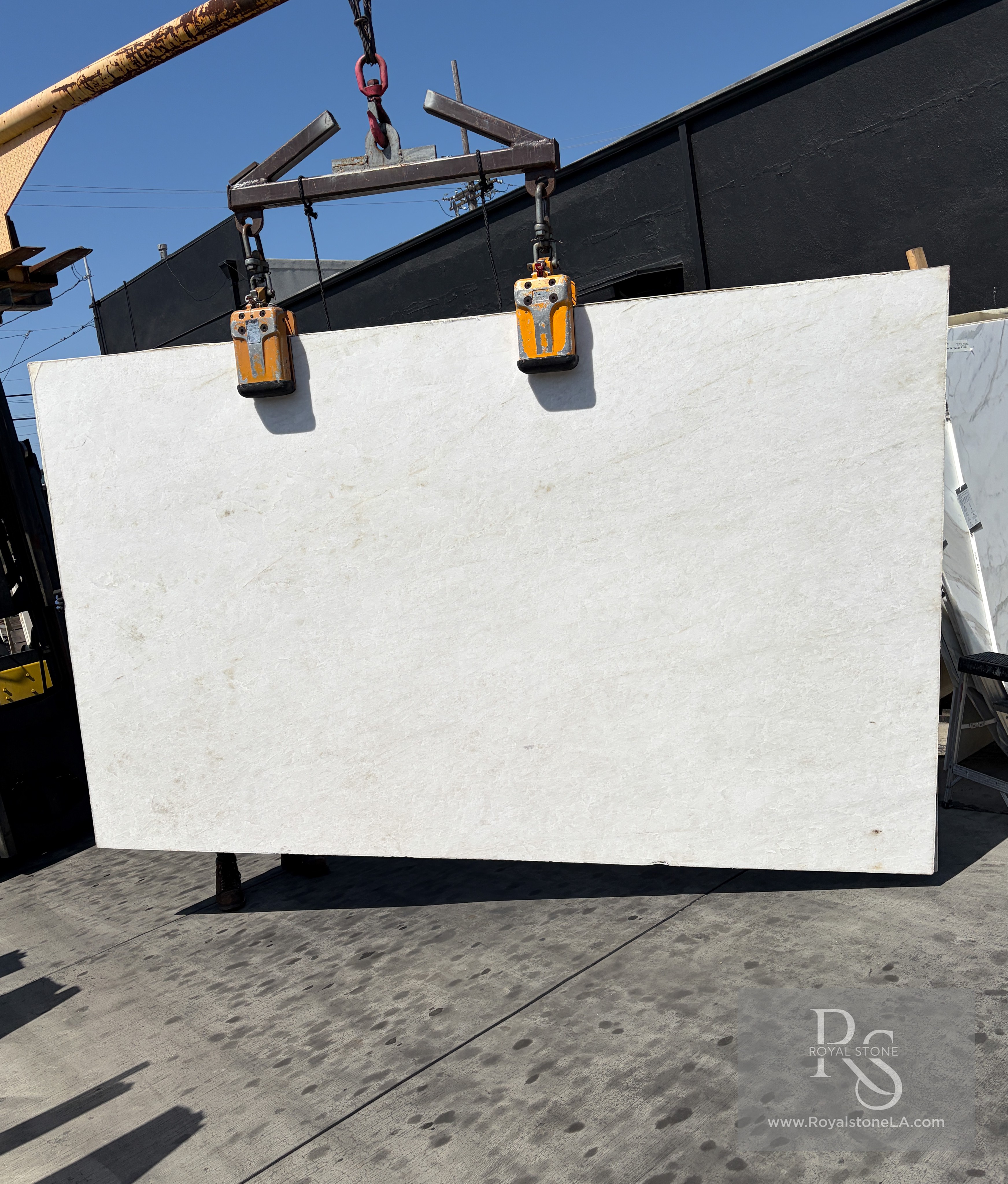 Antolini Patagonia Original quartzite slab in Hard Rock finish at Royal Stone Los Angeles, ivory and amber field with rust veining and deep sculpted surface relief